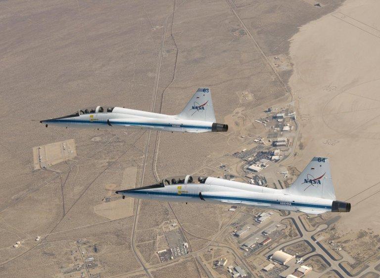 Two T-38A mission support Aircraft Fly in Tight Formation.