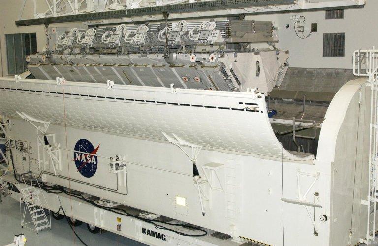 KENNEDY SPACE CENTER, FLA. -- The S1 Integrated Truss Structure is lowered into the payload canister for transport to Atlantis. The first starboard truss segment, the S1 will be attached to the Central truss segment, the S0 Truss, on the International Space Station during mission STS-112. Atlantis is scheduled to launch no earlier than Oct. 2.