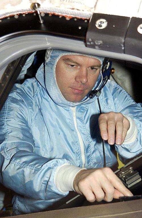 KENNEDY SPACE CENTER, FLA. - STS-114 Pilot James Kelly looks over the windshield in Atlantis. He and other crew members are at KSC to take part in Crew Equipment Interface Test activities, which include checking out the payload and orbiter. STS-114 is a utilization and logistics flight (ULF-1) that will carry Multi-Purpose Logistics Module Raffaello and the External Stowage Platform (ESP-2), as well as the Expedition 7 crew, to the International Space Station. Launch is targeted for March 1, 2003.