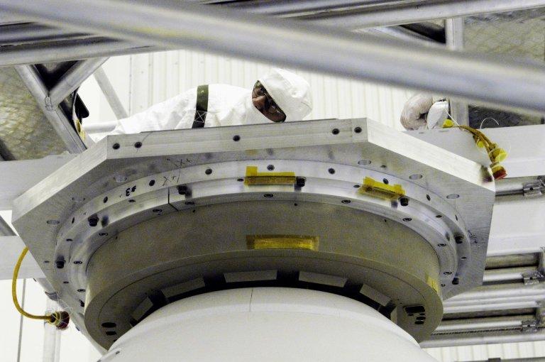 KENNEDY SPACE CENTER, FLA. - Workers in the Payload Hazardous Servicing Facility look over the aeroshell enclosing Mars Exploration Rover 2 and lander that is being moved to a rotation table for a spin stabilization test. There are two identical rovers that will land at different regions of Mars and are designed to cover roughly 110 yards each Martian day over various terrain. Each rover will carry five scientific instruments that will allow it to search for evidence of liquid water that may have been present in the planet's past. The first rover, MER-A, is scheduled to launch June 5 from Cape Canaveral Air Force Station. The second is scheduled for launch June 25.