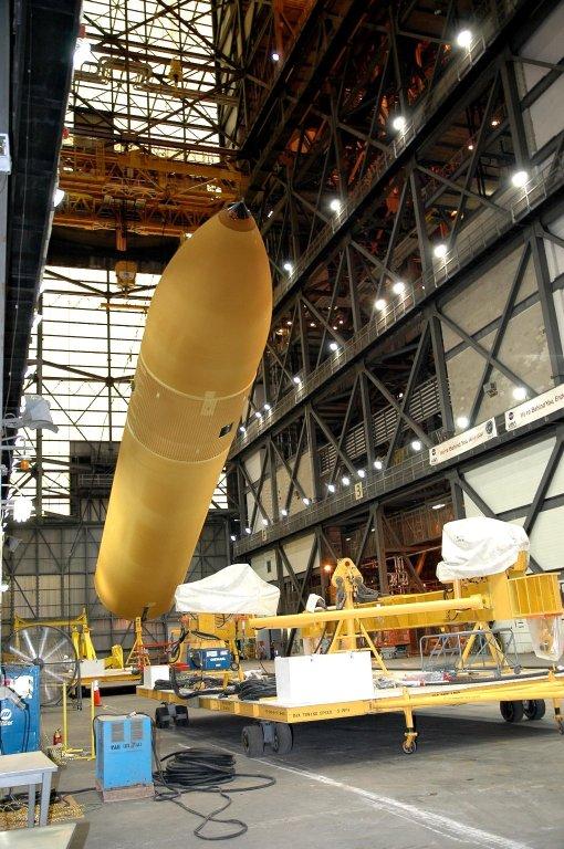 KENNEDY SPACE CENTER, FLA. - Inside NASA Kennedy Space Center?s Vehicle Assembly Building, External Tank 119 is lowered to a horizontal position. Then it will be placed on a transporter in the transfer aisle to be moved to the barge at the Turn Basin. The tank will embark on a voyage around the Florida peninsula to the Michoud Assembly Facility in New Orleans. Delivered to KSC in June, ET-119 is the third newly redesigned tank.