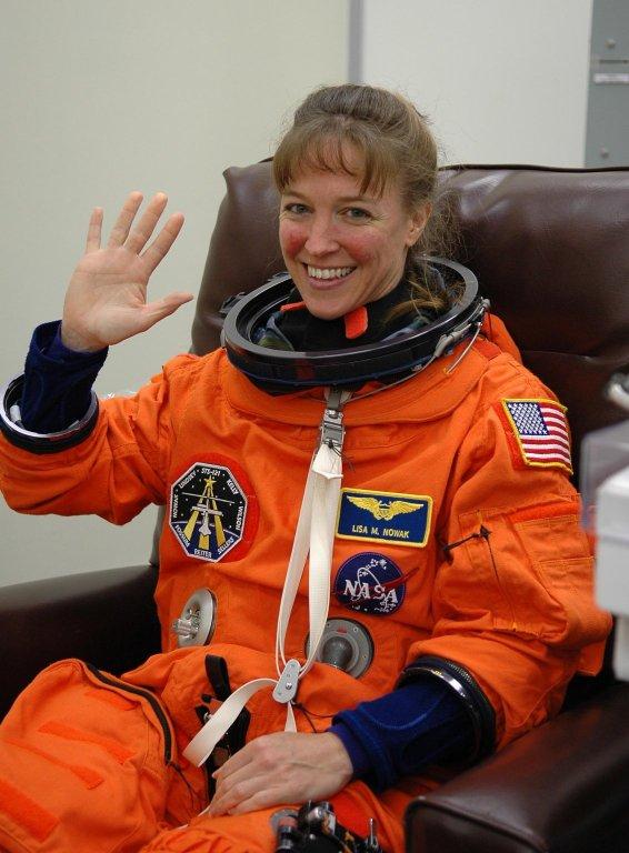 KENNEDY SPACE CENTER, FLA. - STS-121 Mission Specialist Lisa Nowak is happy to be making a third launch attempt on the mission. She is suiting up before heading to Launch Pad 39B. The July 2 launch attempt was scrubbed due to the presence of showers and thunderstorms within the surrounding area of the launch site. The launch of Space Shuttle Discovery on mission STS-121 is the 115th shuttle flight and the 18th U.S. flight to the International Space Station. During the 12-day mission, the STS-121 crew will test new equipment and procedures to improve shuttle safety, as well as deliver supplies and make repairs to the International Space Station. Photo credit: NASA/Kim Shiflett