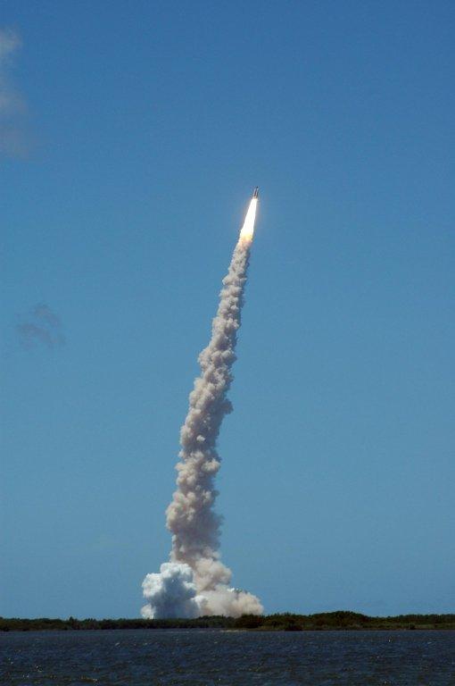 KENNEDY SPACE CENTER, FLA. - Viewed from the NASA Causeway, Space Shuttle Discovery makes a perfect launch as it shoots into the blue sky with its own Fourth of July fireworks. The launch made history as it was the first ever launch on Independence Day. Liftoff was on-time at 2:38 p.m. EDT. During the 12-day mission, the STS-121 crew of seven will test new equipment and procedures to improve shuttle safety, as well as deliver supplies and make repairs to the International Space Station. Landing is scheduled for July 16 or 17 at Kennedy's Shuttle Landing Facility. Photo credit: NASA/Carl Winebarger