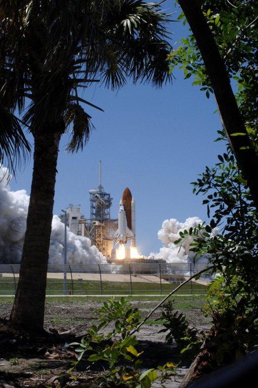 KENNEDY SPACE CENTER, FLA. - Framed by palm trees, Space Shuttle Discovery lifts off Launch Pad 39B at 2:38 p.m. EDT. The fiery display fit the day: Fourth of July. The launch made history as it was the first ever launch on Independence Day. During the 12-day mission, the STS-121 crew of seven will test new equipment and procedures to improve shuttle safety, as well as deliver supplies and make repairs to the International Space Station. Landing is scheduled for July 16 or 17 at Kennedy's Shuttle Landing Facility. Photo credit: NASA/Sandy Joseph, Robert Murray