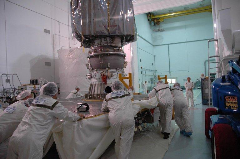 KENNEDY SPACE CENTER, FLA. ? At the Astrotech payload processing facility, workers roll the uncanned Dawn spacecraft into an inner room. Dawn was returned from Launch Pad 17-B at Cape Canaveral Air Force Station to Astrotech to await a new launch date. The launch opportunity extends from Sept. 7 to Oct. 15. Dawn is the ninth mission in NASA's Discovery Program. The spacecraft will be the first to orbit two planetary bodies, asteroid Vesta and dwarf planet Ceres, during a single mission. Vesta and Ceres lie in the asteroid belt between Mars and Jupiter. It is also NASA?s first purely scientific mission powered by three solar electric ion propulsion engines. NASA/Charisse Nahser