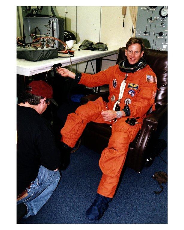 STS-83 Mission Specialist Michael L. Gernhardt is assisted into his launch/entry suit in the Operations and Checkout (O&C) Building. He first flew in this capacity on STS-69. He has been a professional deep sea diver and engineer and holds a doctorate in bioengineering. Gernhardt will be in charge of the Blue shift and as flight engineer will operate and maintain the orbiter while Halsell and Still are asleep as members of the Red shift. He will also back them up on the flight deck during the ascent and re-entry phases of the mission. Gernhardt and six fellow crew members will shortly depart the O&C and head for Launch Pad 39A, where the Space Shuttle Columbia will lift off during a launch window that opens at 2:00 p.m. EST, April 4