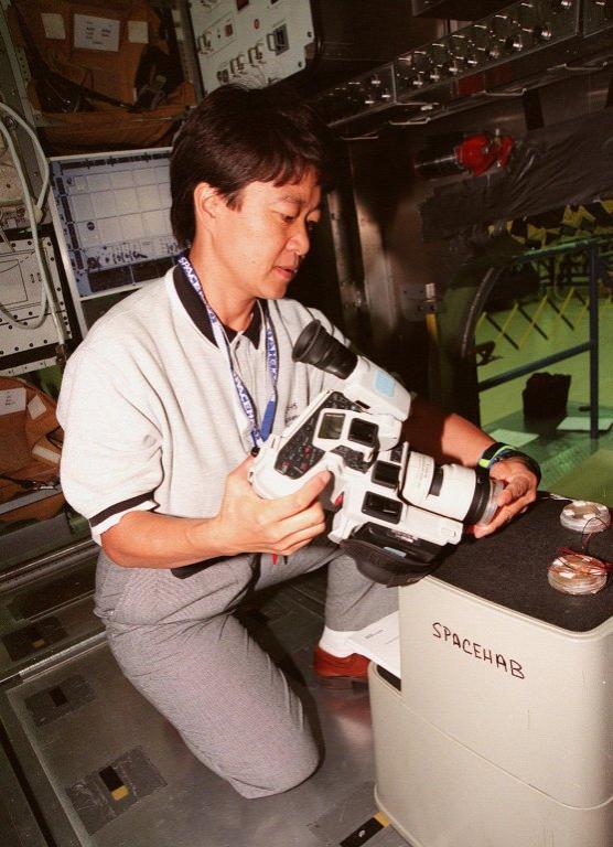 KENNEDY SPACE CENTER, FLA. -- STS-95 Payload Specialist Chiaki Mukai, representing the National Space Development Agency of Japan (NASDA), looks over part of the equipment for the SPACEHAB during familiarization at the SPACEHAB Payload Processing Facility, Cape Canaveral. The mission, scheduled to launch Oct. 29, includes research payloads such as the Spartan solar-observing deployable spacecraft, the Hubble Space Telescope Orbital Systems Test Platform, the International Extreme Ultraviolet Hitchhiker, as well as the SPACEHAB single module with experiments on space flight and the aging process