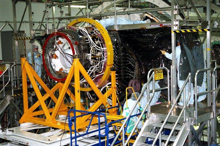 KENNEDY SPACE CENTER, FLA. -- Boeing technicians join Node 1 for the International Space Station (ISS) with the Pressurized Mating Adapter (PMA)-1 in KSC?s Space Station Processing Facility. This PMA, identifiable by its bright red ring, is a cone-shaped connector for the space station?s structural building block, known as Node 1. Seen here surrounded by scaffolding, Node 1 will have two PMAs attached, the second of which is scheduled for mating to the node in January 1998. The node and PMAs, which will be the first element of the ISS, are scheduled to be launched aboard the Space Shuttle Endeavour on STS-88 in July 1998