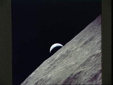 Cresent Earth rises above lunar horizon